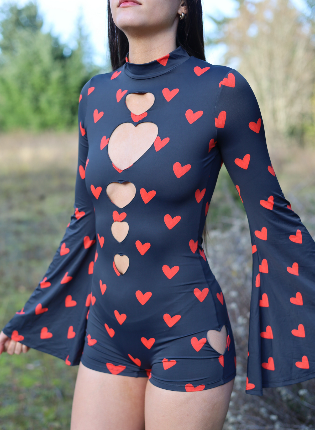 Close-up of the heart-shaped chest cutout and red heart print on the black bodysuit