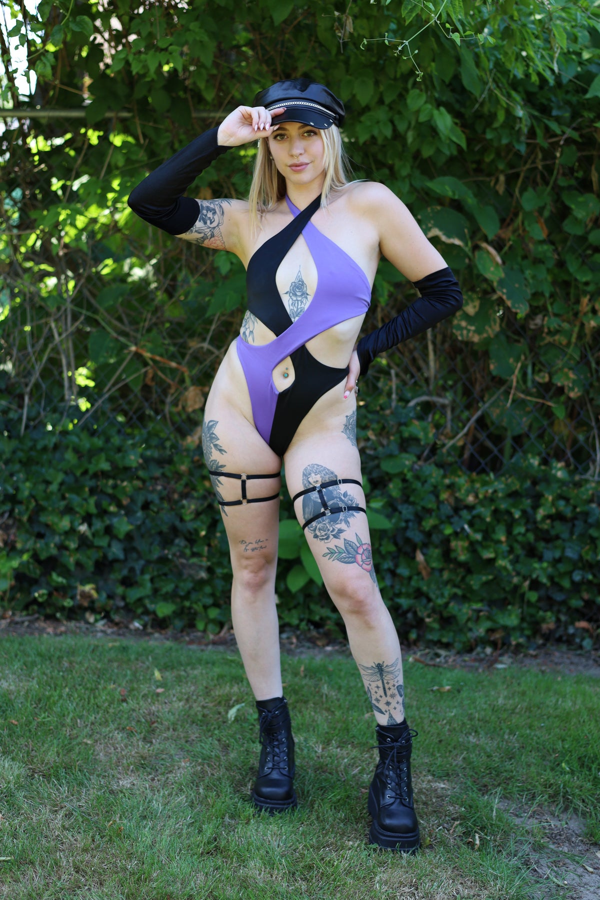 Front view of the purple, black, and white Vortex Bodysuit with asymmetric cutouts